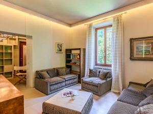 a living room with two couches and a table at Holiday Home La Rina by Interhome in Dervio