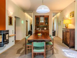 a dining room with a wooden table and chairs at Holiday Home La Rina by Interhome in Dervio +44 photos