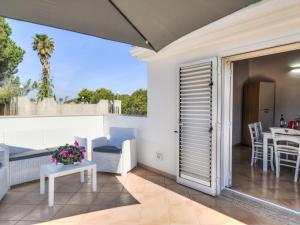 a patio with a table and chairs on a balcony at Apartment MareLuna by Interhome in Fontane Bianche
