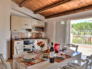 a kitchen and dining room with a table and chairs at Apartment MareLuna by Interhome in Fontane Bianche