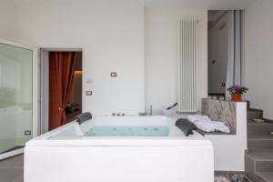 a bath tub in a room with a staircase at Le Suite di Magda Relax & Rooms in Polignano a Mare +88 photos