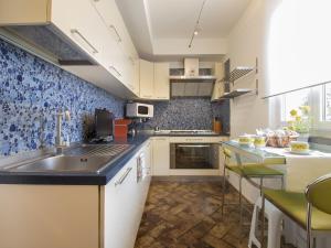 a kitchen with a sink and a counter top at Holiday Home Fiumetto by Interhome in Marina di Pietrasanta