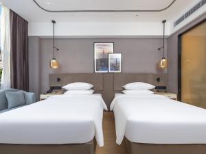 Voodi või voodid majutusasutuse Country Inn & Suites by Radisson Shenzhen International Convention and Exhibition Center toas