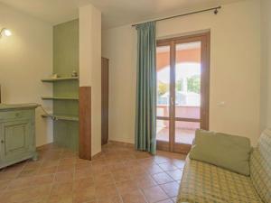 a living room with a couch and a sliding glass door at Apartment Thermae Apartment 23 by Interhome in Sorano +29 photos