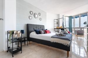 a bedroom with a bed and a balcony at CT 301 - Faro's Fuengirola Centro Studio in Fuengirola +24 photos