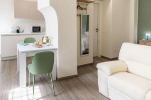 a living room with a table and a couch at Borgo dei Nonni - Menaggio by LoveComo in Menaggio