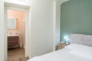 メナッジョにあるBorgo dei Nonni - Menaggio by LoveComoのベッドのある寝室と洗面台のある浴室 +17枚の写真