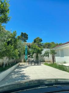 a patio with a table and a blue umbrella at Gold apartament vlore free parking in Vlorë