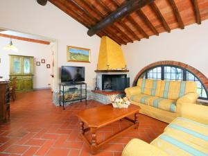 a living room with a couch and a fireplace at Apartment Arco by Interhome in Podere Panzano