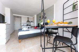 a bedroom with a bed and a table with a bowl of fruit at CT 301 - Faro's Fuengirola Centro Studio in Fuengirola
