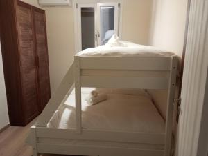 a white bunk bed in a room with a mirror at Alemarni Syros in Ermoupoli