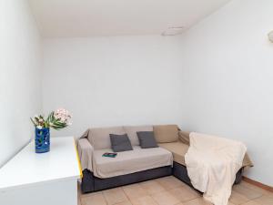 a living room with a couch and a table at Holiday Home Mare-3 by Interhome in Li Valcaggi