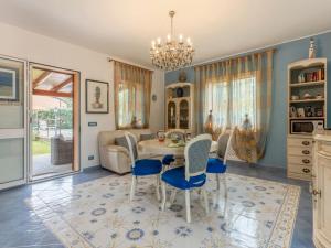 a dining room with a table and chairs at Villa Olivella by Interhome in Lascari