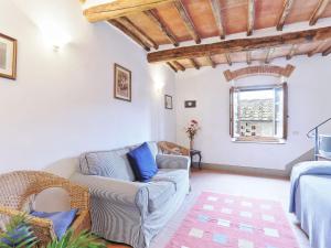 a living room with a couch and a chair at Apartment Il Forno-14 by Interhome in Grassina