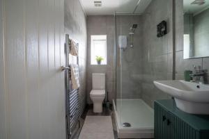 a bathroom with a sink and a toilet and a shower at The Station Inn Apartment in Yeadon +52 photos