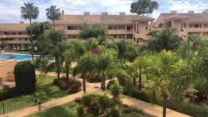 an aerial view of a resort with a pool and palm trees at Luxury Duplex Penthouse in Marbella