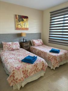 a bedroom with two beds with blue towels on them at Luxury Duplex Penthouse in Marbella
