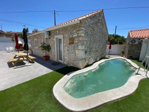 a house with a swimming pool in front of it at Palheiro do Rei in Fátima