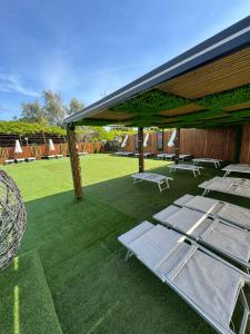 a group of chaise lounges under a pavilion at Hotel Borbonico di Pietrarsa in Portici