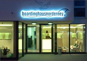 a man is standing in the front of a building at Apartments Boardinghaus Norderney in Norderney