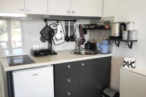 a kitchen with a sink and a counter top at Faros Sea View - Sifnos in Faros