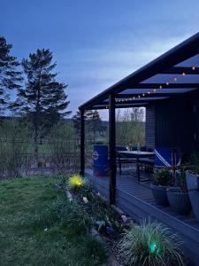 eine Terrasse mit einem Picknicktisch und Lichtern darauf in der Unterkunft Sea Side Tiny House London in Salzhemmendorf