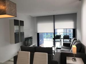 a living room with two couches and a table at Sea Senses by Mar Holidays in Torrevieja