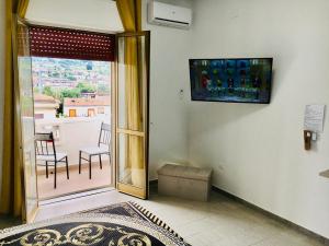 a room with a sliding glass door to a balcony at Bed and Breakfast Adriano in Ponte