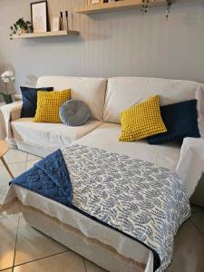 a couch with pillows on it in a living room at addview 1 in Nafplio