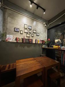 a wooden bench in a room with a table at Hansa Hostel Bangkok Khaosan in Bangkok