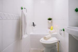 een witte badkamer met een toilet en een wastafel bij Piso compartido Delyrent, SFJ in Jaén