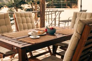 a wooden table with a plate of food on a patio at Marina View Syvota in Sivota
