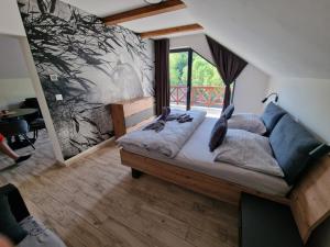 a bedroom with a bed with two birds on it at Hellene Snow Starý Smokovec in Starý Smokovec