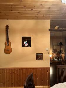 a guitar on the wall of a room at Populus Sunset "You-hi"-Atsuta - Vacation STAY 05432v in Ishikari