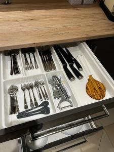 a drawer filled with utensils on a counter at Ammersee Garten Appartment in Herrsching am Ammersee