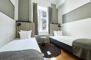 a hotel room with two beds and a window at Hotel Sct. Thomas in Copenhagen +61 photos