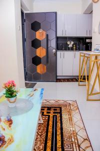 a kitchen with a table and a counter top at Comfort & Style 1Bed Apartment, Luxore, Syokimau in Nairobi