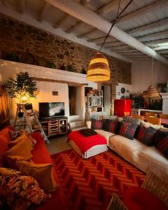 a living room with a couch and a tv at Monte Refúgio do Silêncio in Portalegre +49 photos