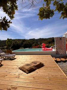 a wooden deck with a pillow on top of a house at Monte Refúgio do Silêncio in Portalegre
