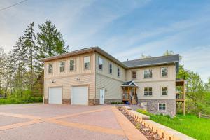 a large house with a garage at Sprawling Wisconsin Dells Home with Deck and Fire Pit in Wisconsin Dells
