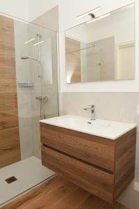 a bathroom with a sink and a shower with a mirror at NEW Villa Tosca in Bardolino +44 photos