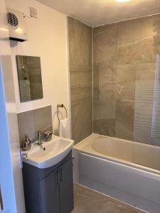 a bathroom with a sink and a tub and a shower at Centre reache in Southend-on-Sea