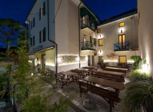 a group of wooden benches in front of a building at B&B 7 Vizi in Col&agrave; di Lazise