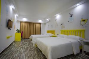 Postelja oz. postelje v sobi nastanitve Zhangjiajie Cat Theme Inn