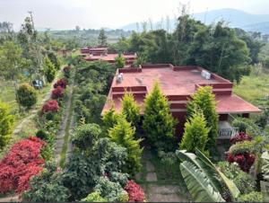 an aerial view of a house with trees and flowers at Golden Hill Resort in Santaveri