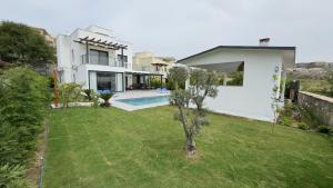 a house with a yard with a swimming pool at Villa Akasya with private pool in Bogazici