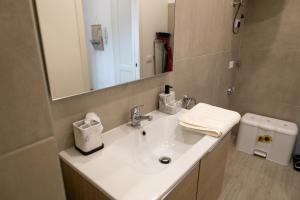 a bathroom with a white sink and a mirror at Elegante appartamento nel cuore di Omegna in Omegna +9 photos