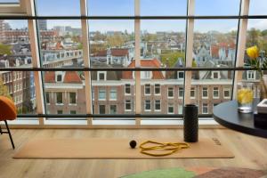 a room with a view of a city from a window at Avani Museum Quarter Amsterdam Hotel in Amsterdam