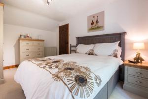 een slaapkamer met een bed met een bloemendeken erop bij Charming Guest House in Cornish Countryside in Bodmin
