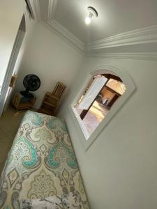 a bedroom with a bed and a mirror on the wall at Quarto cápsula in Saquarema +18 photos